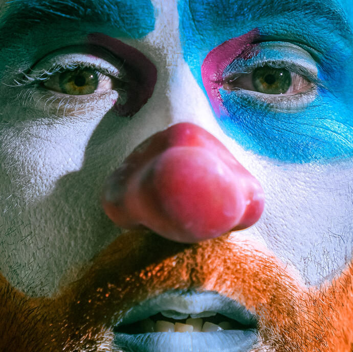 Close up photo of Ryan Pater wearing clown makeup and red nose